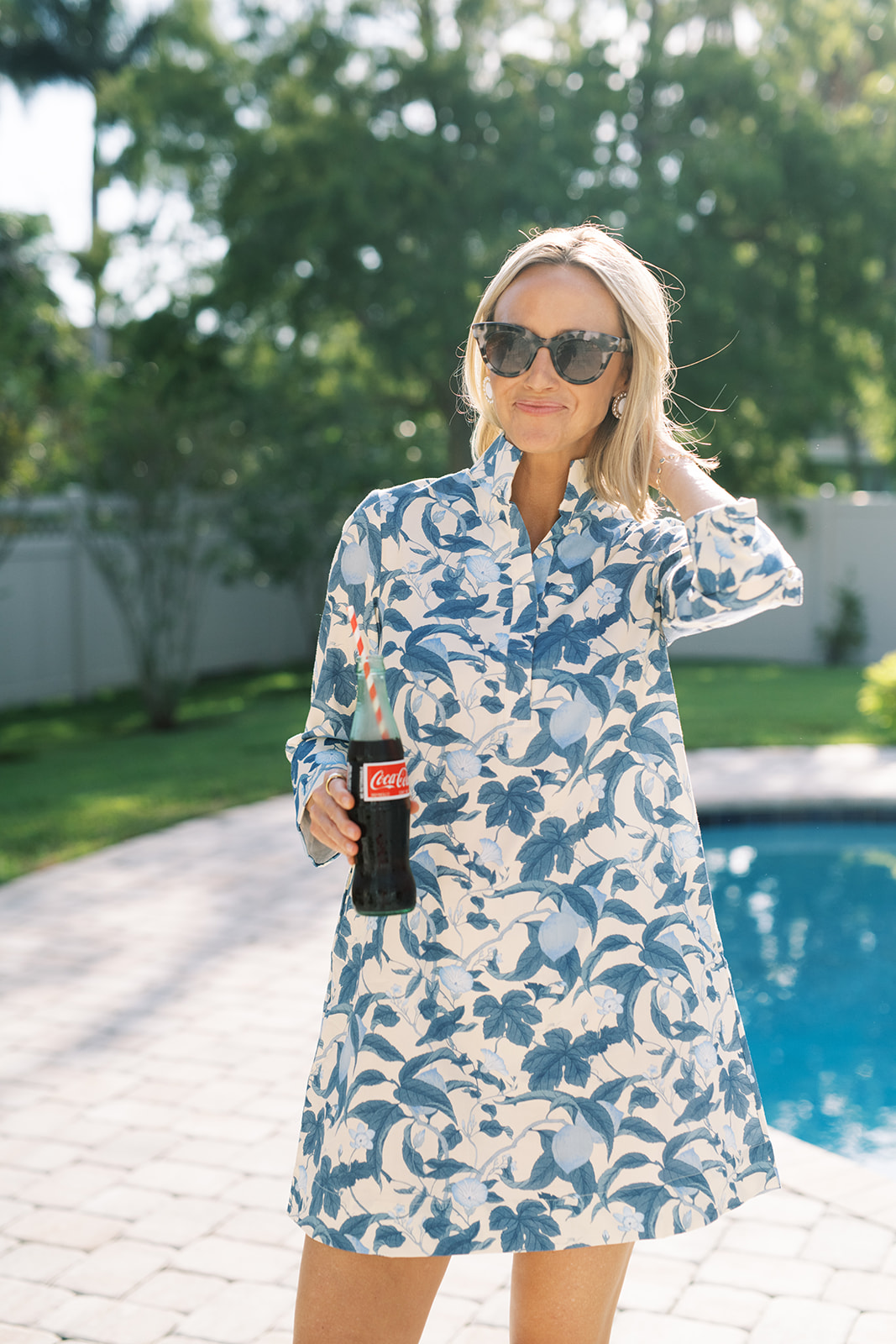 Bonnie Blossom Megan Dress from Tuckernuck woman blue and white dress enjoying a coke